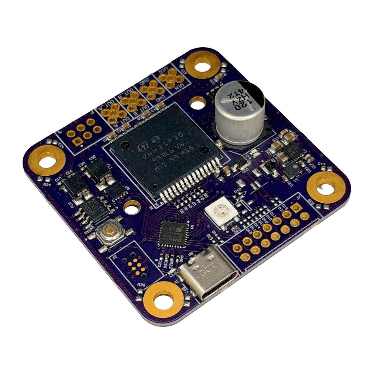 Photograph of the purple R1 Motor Control Module board at an angle, showing the large IC, capacitor, USB-C connector, gold contact pads and mounting holes.